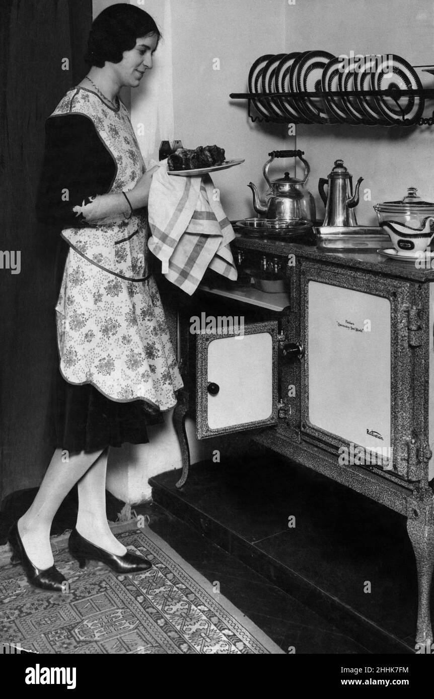 Femme de ménage avec son nouveau four à gaz et table de cuisson Flecthers Queensday New World.19th avril 1930 Banque D'Images