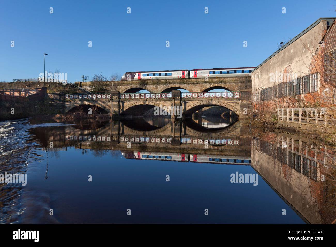 Arriva CrossCountry trains classe 220 train traversant le viaduc de Burton Weir, River Don, Attercliffe, Sheffield, se reflète dans l'eau ci-dessous Banque D'Images