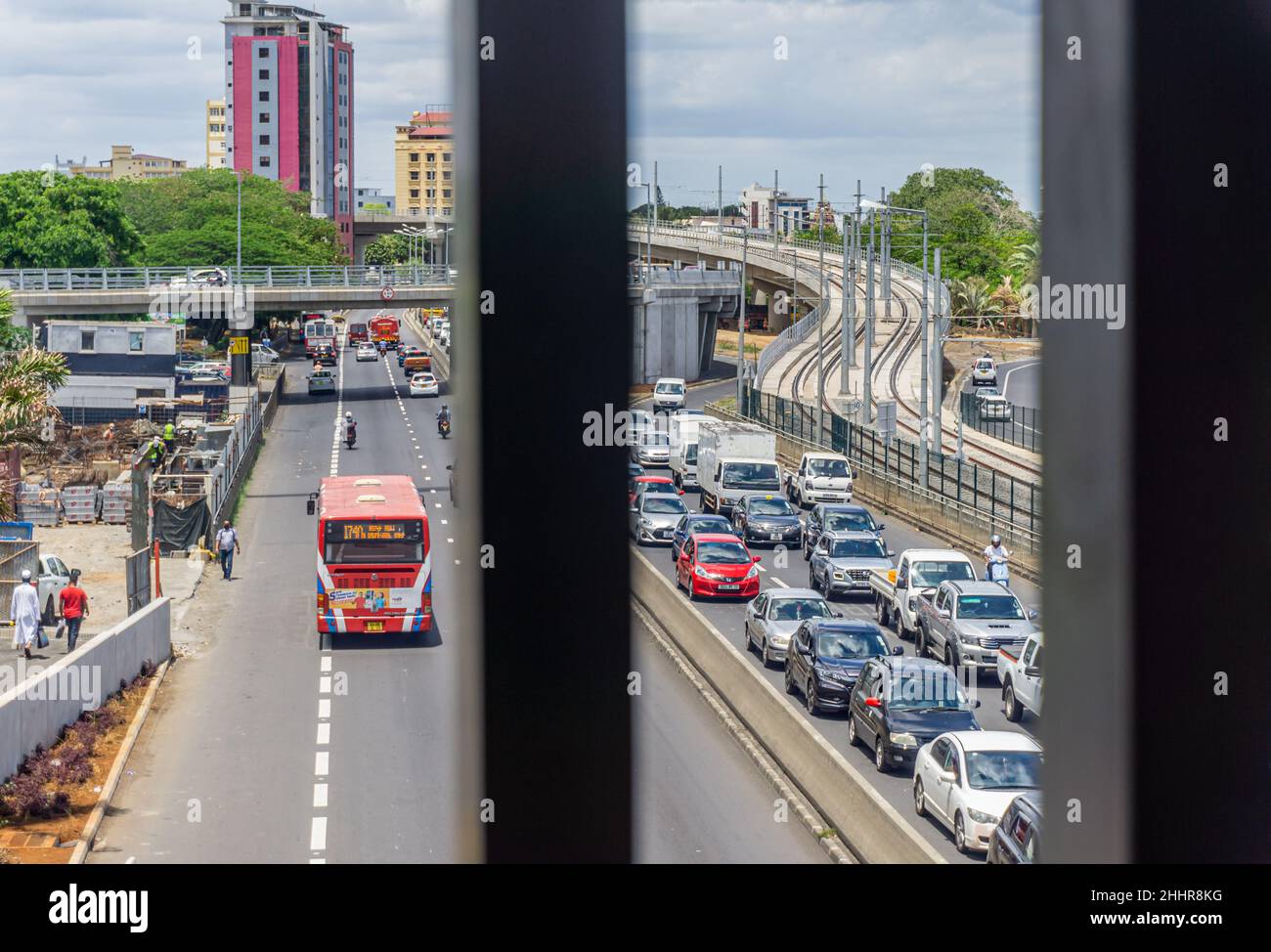 Port Louis, Maurice, décembre 2021 - circulation routière très fréquentée entrant dans la capitale, vue à travers la balustrade d'un passage pour piétons Banque D'Images