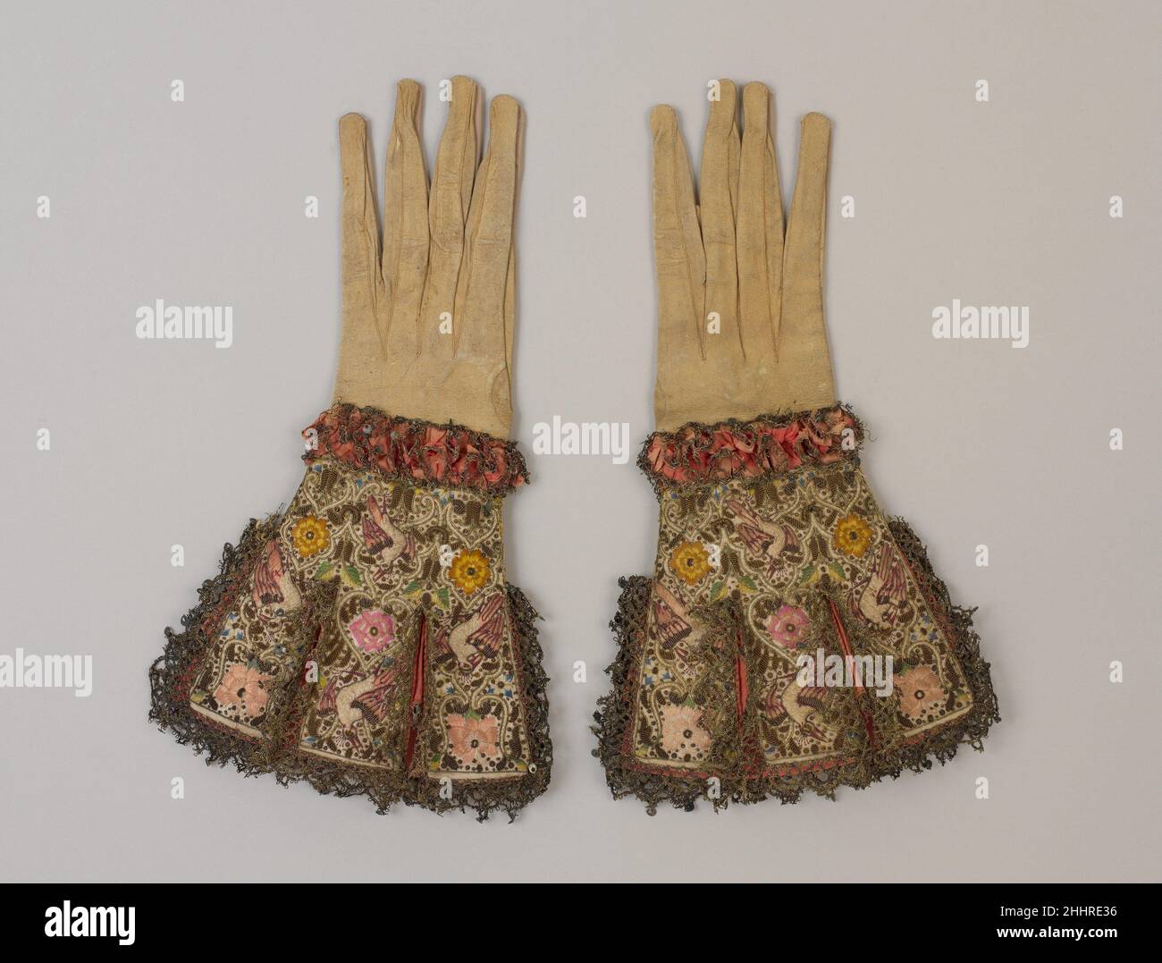 Paire de gants 1600–1625 Britannique au début de la période moderne, les gants étaient des accessoires essentiels.Comme aujourd'hui, ils avaient des fonctions pratiques : ils étaient utilisés pour la protection ou la chaleur, et, dans certains cas, des gants parfumés étaient utilisés à des fins médicales.Mais ils étaient aussi de puissantes extensions des actions sociales ; ils étaient des symboles de statut et d'obligation, jetés en défi ou précieux comme des jetons d'affection.De cette façon, les gants ont été un plaisir remarquable—dans les peintures, ils sont souvent tenus plutôt que portés.Cette paire présente des oiseaux de paradis préensants, des œillets, des roses, et de minuscules borages—possible Banque D'Images