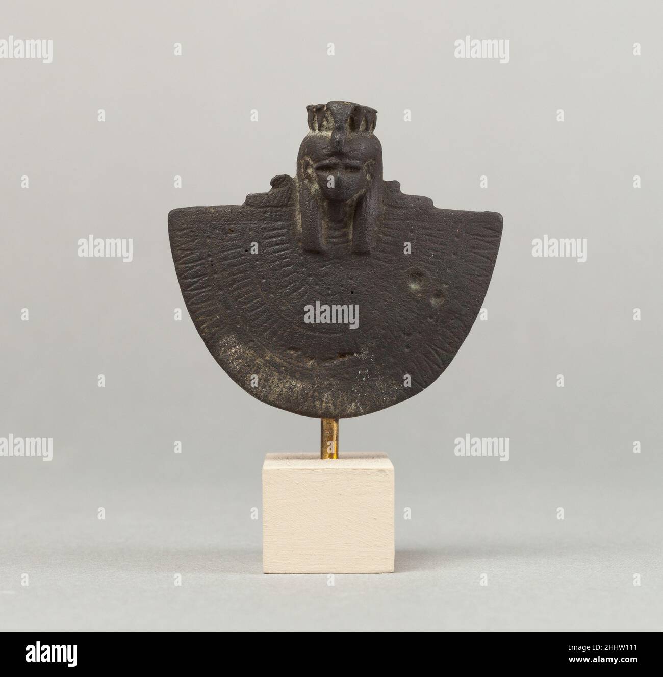 AEGIS d'une déesse femelle 664–30 C.-B. période tardive–période Ptolemaic l'AEGIS est un objet qui comprend le buste d'une divinité avec un col large en dessous.Les cols larges sont généralement accompagnés d'un menat, un contrepoids qui pend à l'arrière du cou, équilibrant le poids du col lourd et élaboré sur la poitrine.Bien que cette pièce montre seulement la tête de la déité et le large collier, elle représente la combinaison AEGIS-menat, qui n'était pas seulement un ornement personnel mais a également joué un rôle important dans le culte.C'était un symbole protecteur et était utilisé dans les rituels et les festivals; la tête a permis t Banque D'Images