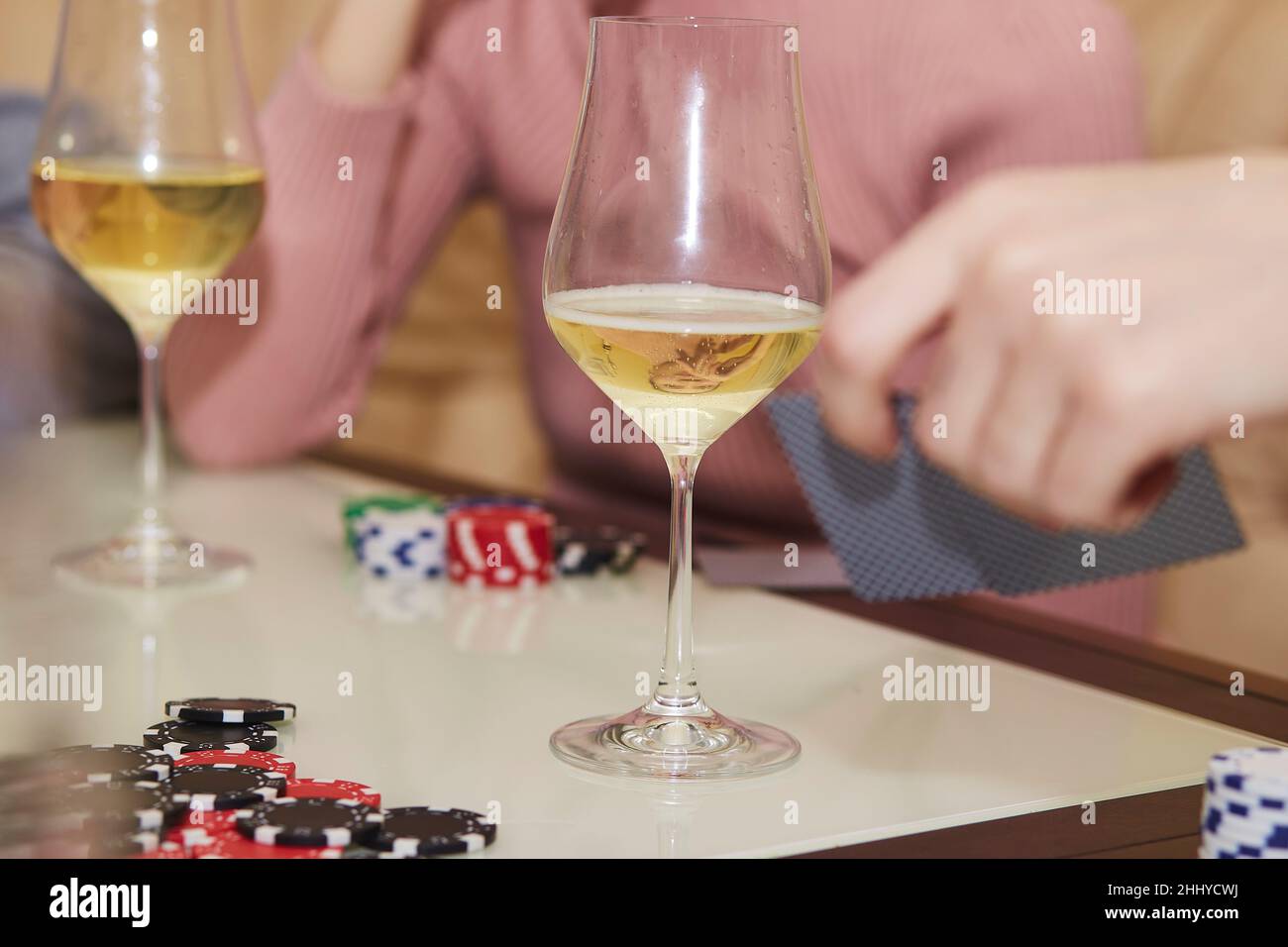 Joueurs de poker avec jetons et cartes gros plan.Verres de champagne.Concept de jeu.Moment sincère.Mise au point sélective. Banque D'Images