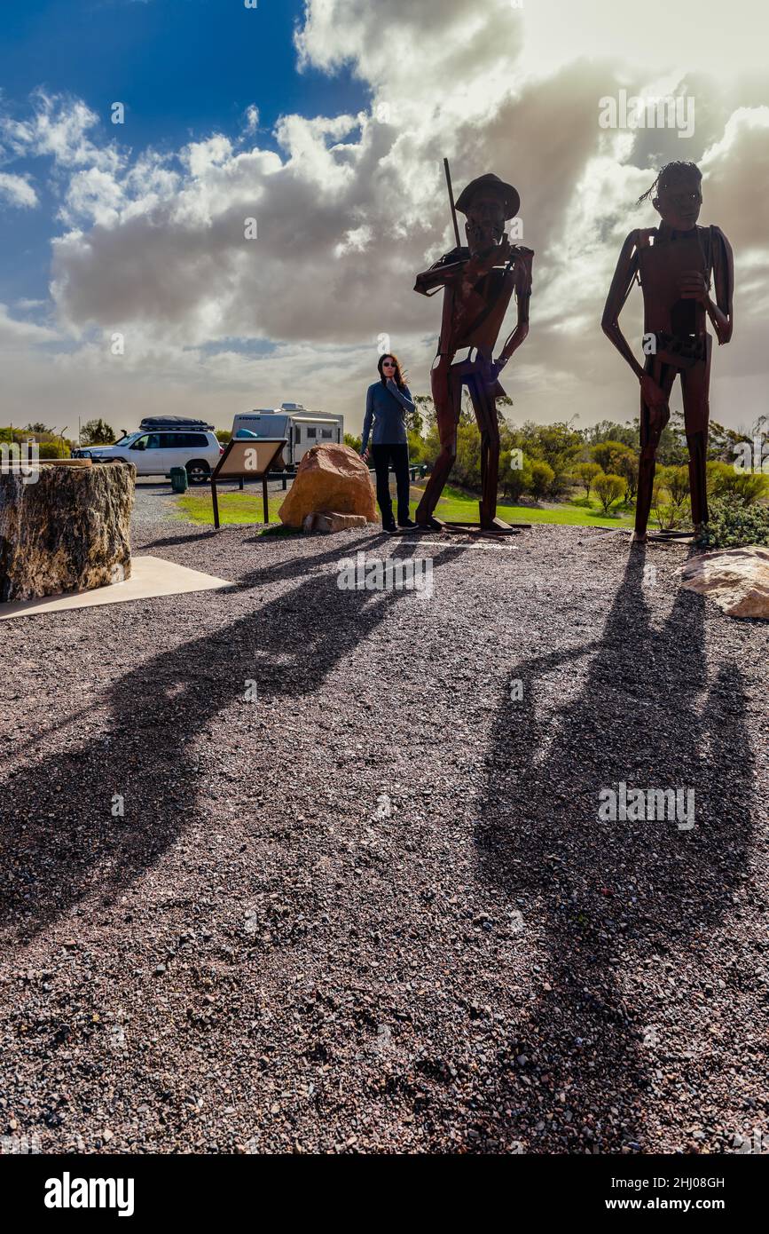 Une touriste féminine se tient à côté des magnifiques figures de fer des explorateurs intrépides, Edward John Eyre & Wylie sur la péninsule d'Eyre en Australie méridionale. Banque D'Images