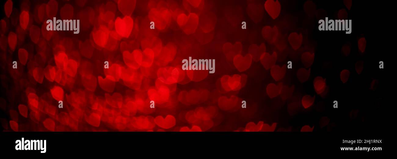 Coeurs rouges, texture de fond bokeh scintillante.Fêtes Saint-Valentin lumières de jour.En-tête abstrait défoqué.Fond d'écran large.Web panoramique Banque D'Images