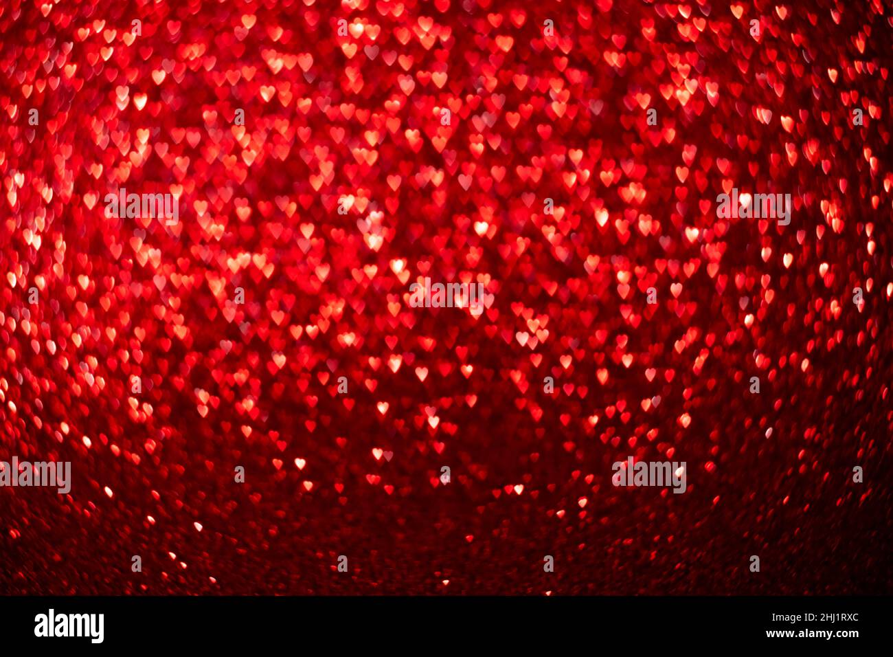 Coeurs rouges, fond de bokeh scintillant, Saint Valentin abstrait texture défocused Banque D'Images