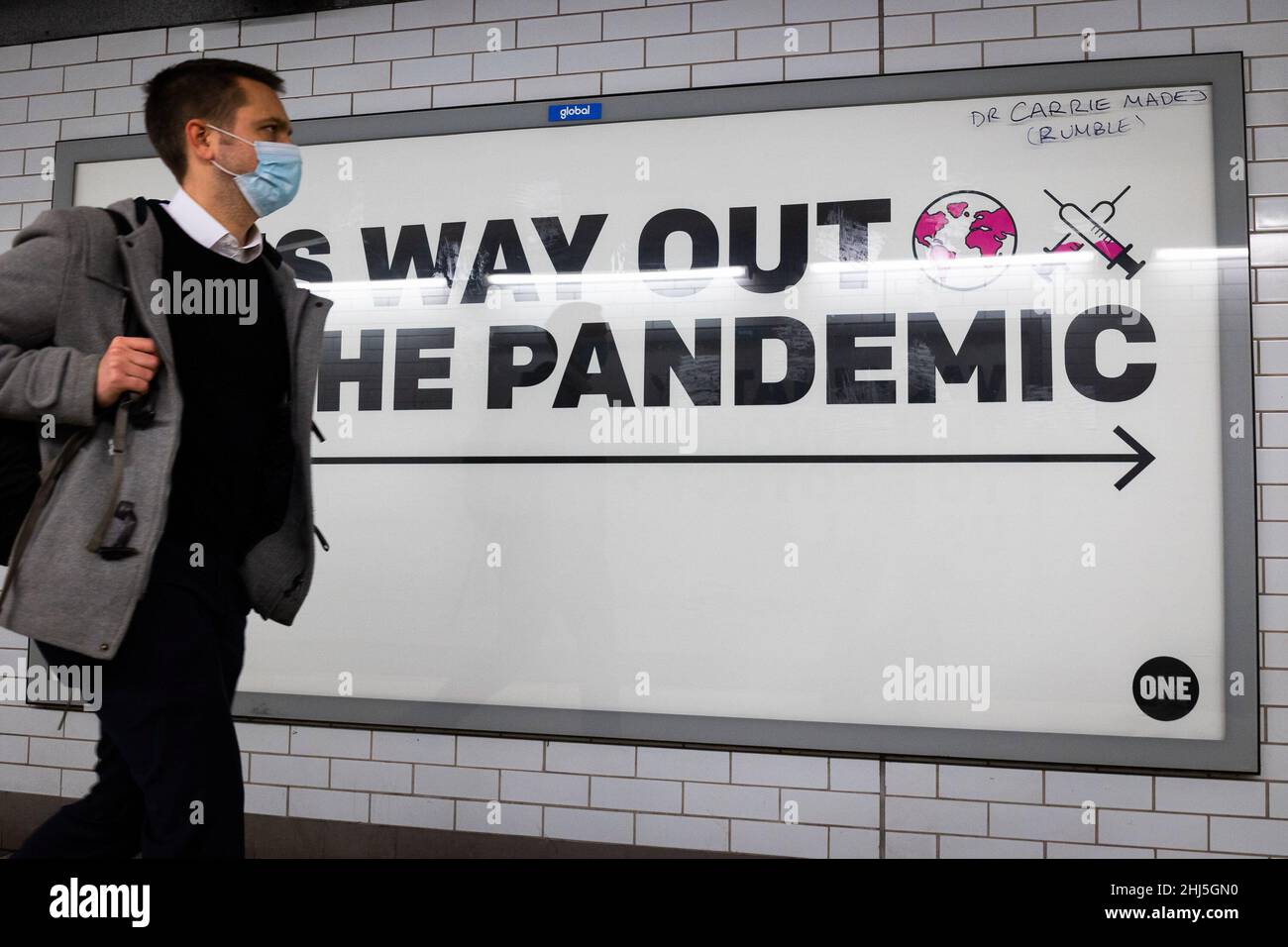 Londres, Royaume-Uni.26th janvier 2022.Un homme portant un masque marche devant un panneau de promotion de la vaccination à Westminster Station à Londres.À partir du 27th janvier, l'utilisation du masque facial dans tous les lieux publics cessera d'être obligatoire car la menace posée par la variante Omicron des sous-camps Covid-19.(Photo de Tejas Sandhu/SOPA Images/Sipa USA) Credit: SIPA USA/Alay Live News Banque D'Images