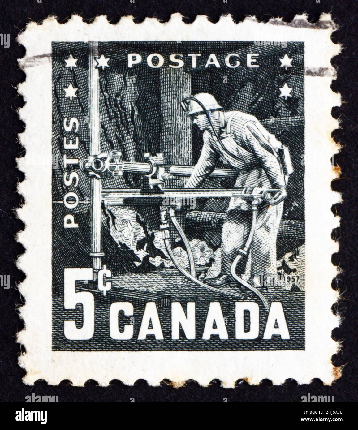 CANADA - VERS 1957 : un timbre imprimé au Canada montre Miner with Pneumatic Drill, 6th Commonwealth Mining and Metallurgical Congress, Vancouver, ci Banque D'Images