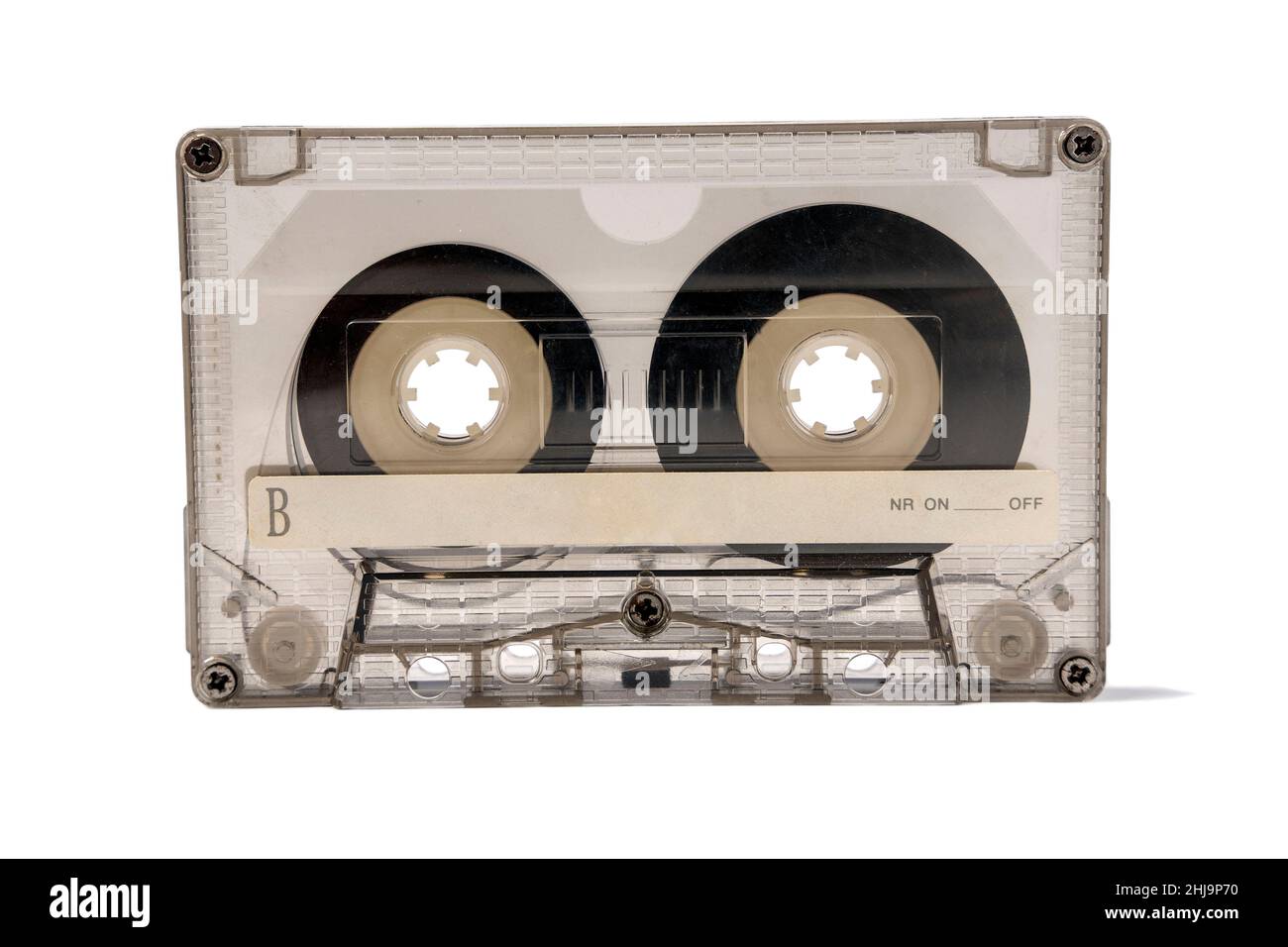 Une ancienne cassette audio transparente pour magnétophone isolée sur fond blanc, un film magnétique est visible à travers le boîtier de la cassette, sou Banque D'Images