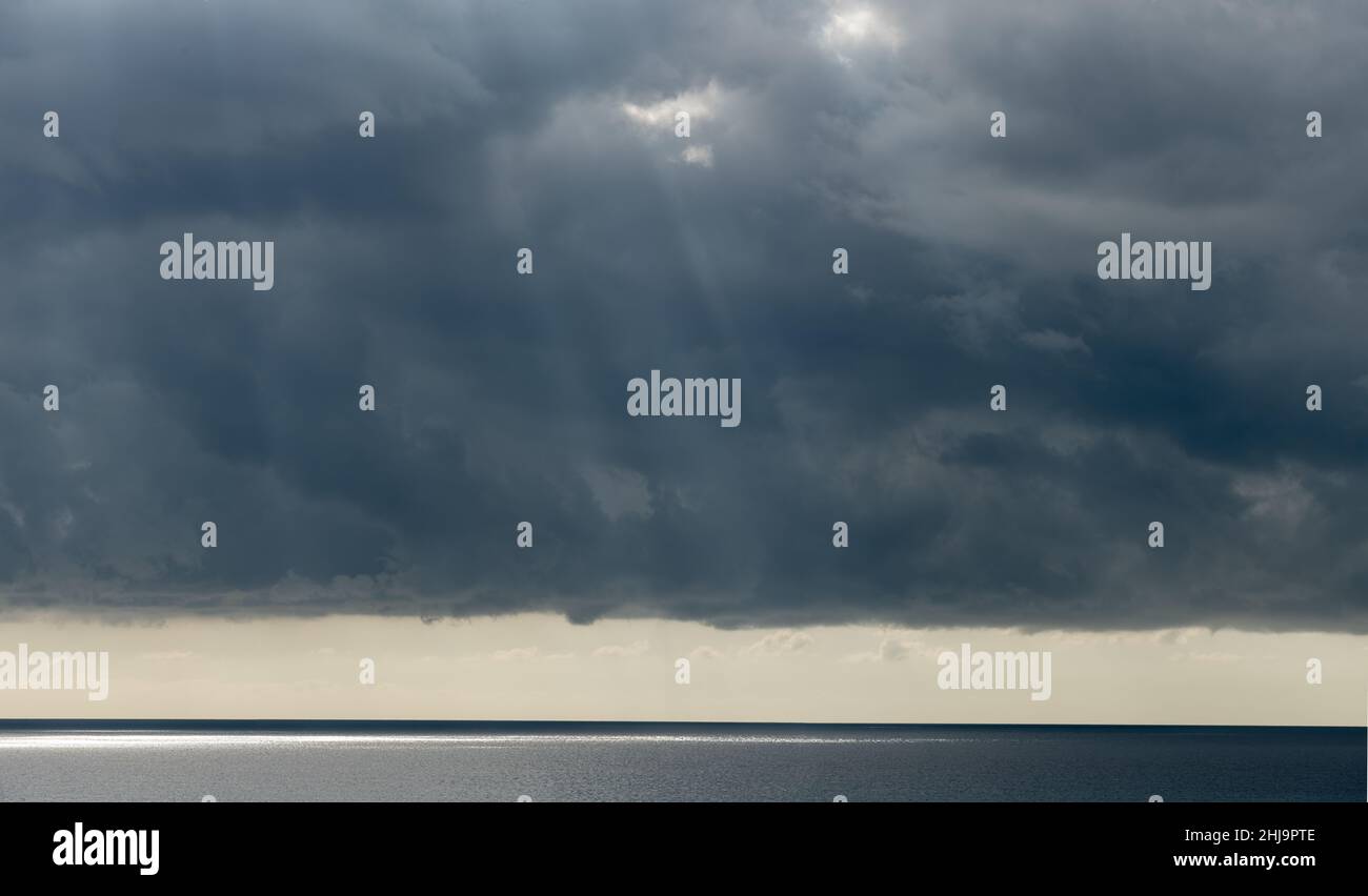 Nuages orageux avec ciel spectaculaire au-dessus de la mer au coucher du soleil Banque D'Images