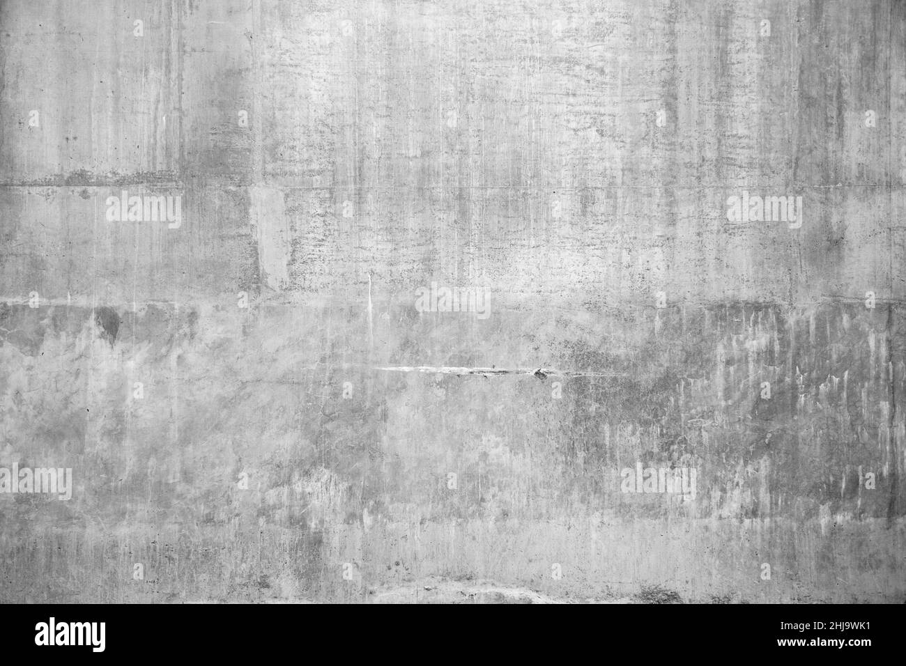 Image d'un mur en béton gris avec des textures rugueuses de grunge fissurées. Banque D'Images