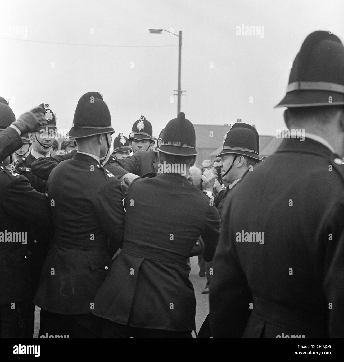 Sir Oswald Mosley se rend à Manchester pour participer à une marche organisée par son Union britannique des partisans des fascistes, dimanche 29th juillet 1962.Quand les quatre-vingt marcheurs se sont rassemblés, une foule en colère les a précipités et Mosley a disparu dans une vague de poings et de bottes volants et ses bannières de groupe ont été déchirées pour les tatouer.La police a brisé la foule des combats et a secouru Mosley, 65 ans, mais la marche s'est rapidement transformée en une émeute causant un mile de terreur avec des combats qui éclatent à quelques mètres.De nombreux marcheurs sont tombés avec des visages qui se saignent et des vêtements déchirés.Les autres ont été pillés avec des pierres, des pièces de monnaie, des choux, des tomates A. Banque D'Images Sir Oswald Mosley se rend à Manchester pour participer à une marche organisée par son Union britannique des partisans des fascistes, dimanche 29th juillet 1962.Quand les quatre-vingt marcheurs se sont rassemblés, une foule en colère les a précipités et Mosley a disparu dans une vague de poings et de bottes volants et ses bannières de groupe ont été déchirées pour les tatouer.La police a brisé la foule des combats et a secouru Mosley, 65 ans, mais la marche s'est rapidement transformée en une émeute causant un mile de terreur avec des combats qui éclatent à quelques mètres.De nombreux marcheurs sont tombés avec des visages qui se saignent et des vêtements déchirés.Les autres ont été pillés avec des pierres, des pièces de monnaie, des choux, des tomates A. Banque D'Images