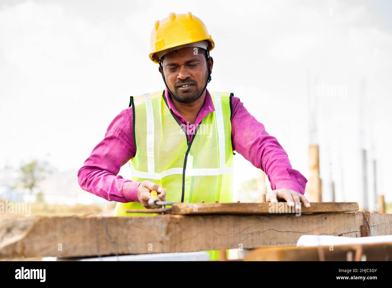 Travailleur indien de la construction avec casque dur cintrer la tige en acier sur le lieu de travail - concept de travailleur dur, le mode de vie de la mise en service quotidienne et les emplois de coler bleu, Banque D'Images