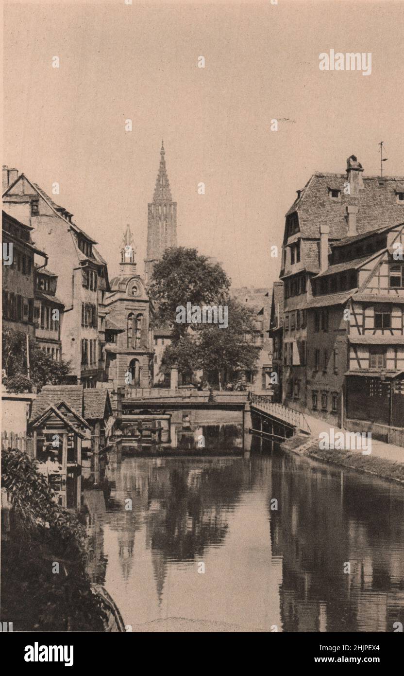 Dominant les anciens et nouveaux bâtiments de Strasbourg, la Tour de la Cathédrale, haute de 465 pieds, l'un des plus beaux d'Europe. Alsace-Lorraine (1923) Banque D'Images