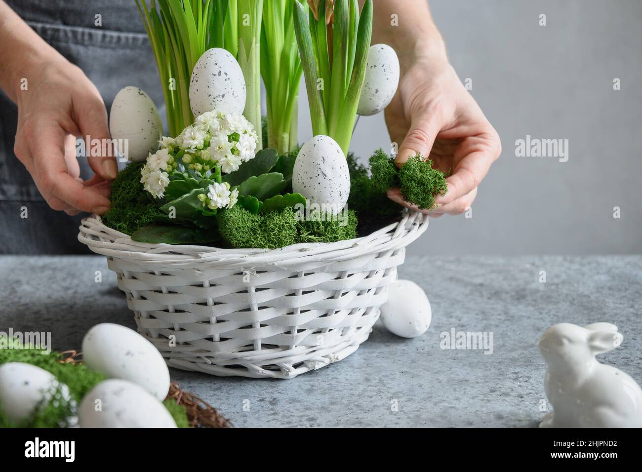 Table de fête de Pâques avec œufs de fête, mousse et lapin. Composition du ressort. Atelier floral. Banque D'Images