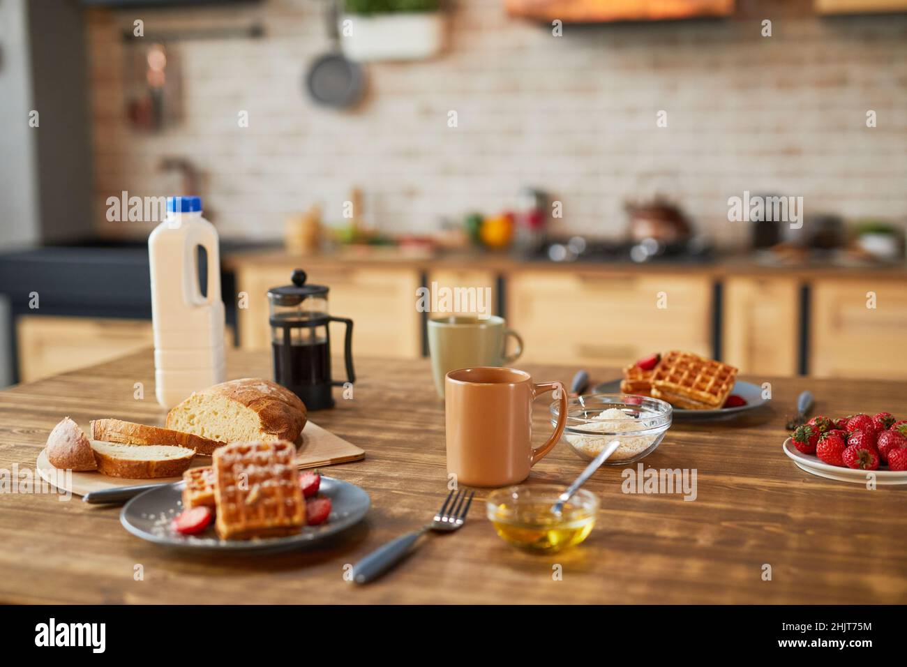 Image d'arrière-plan de gaufres au petit déjeuner sucré avec fraise sur une table en bois dans une cuisine confortable, espace copie Banque D'Images