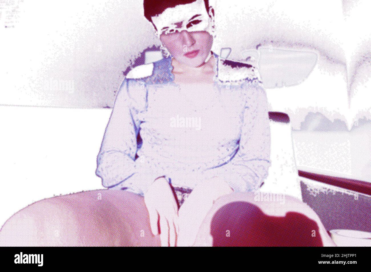 une jeune femme assise sur le canapé avec des effets d'image intéressants Banque D'Images