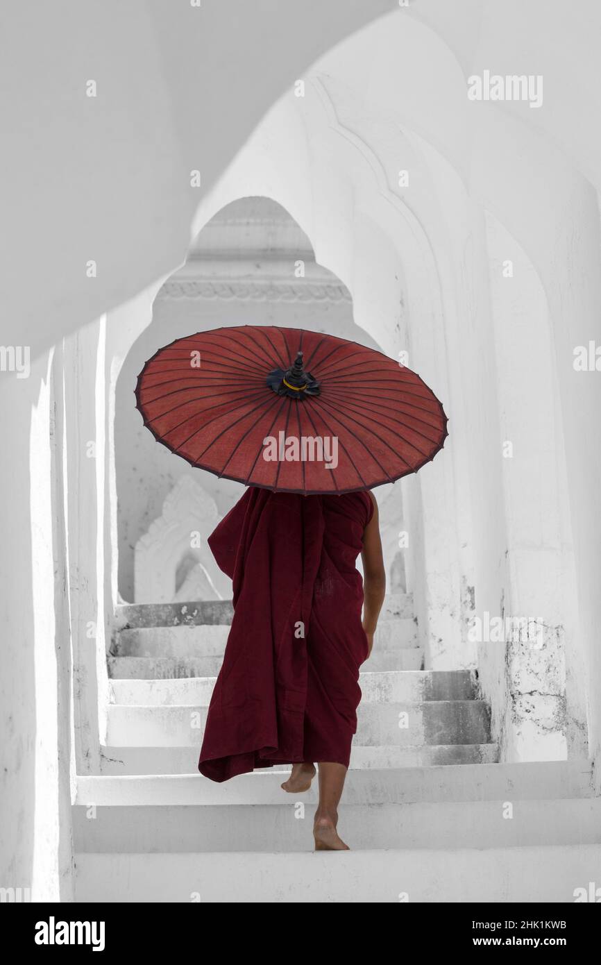 Jeune moine bouddhiste novice tenant le parasol dans l'arche à la Pagode Myatheinda (également connue sous le nom de Pagode Hsinbyume) Mingun, Myanmar (Birmanie), Asie en février Banque D'Images