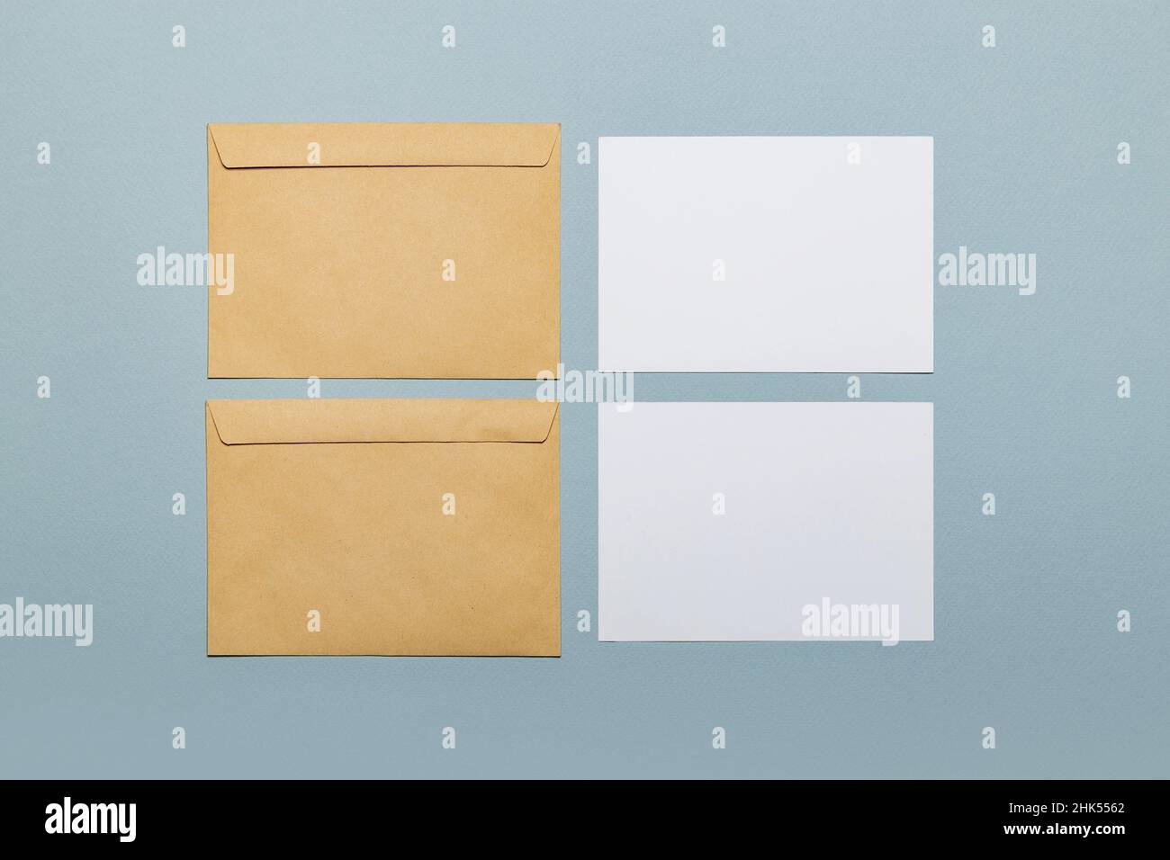 Deux maquettes de carte postale sur fond bleu avec enveloppes artisanales.Maquette de carte. Banque D'Images