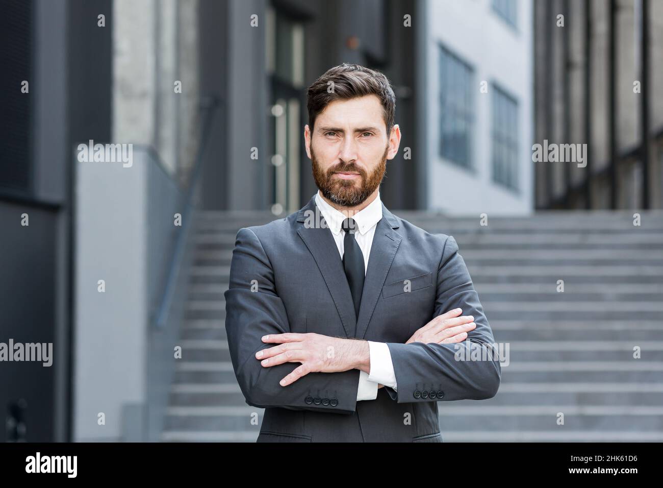 Portrait jeune confiant homme d'affaires caucasien réussi à la recherche de caméra homme d'affaires sérieux debout sur fond urbain de bureau moderne Banque D'Images
