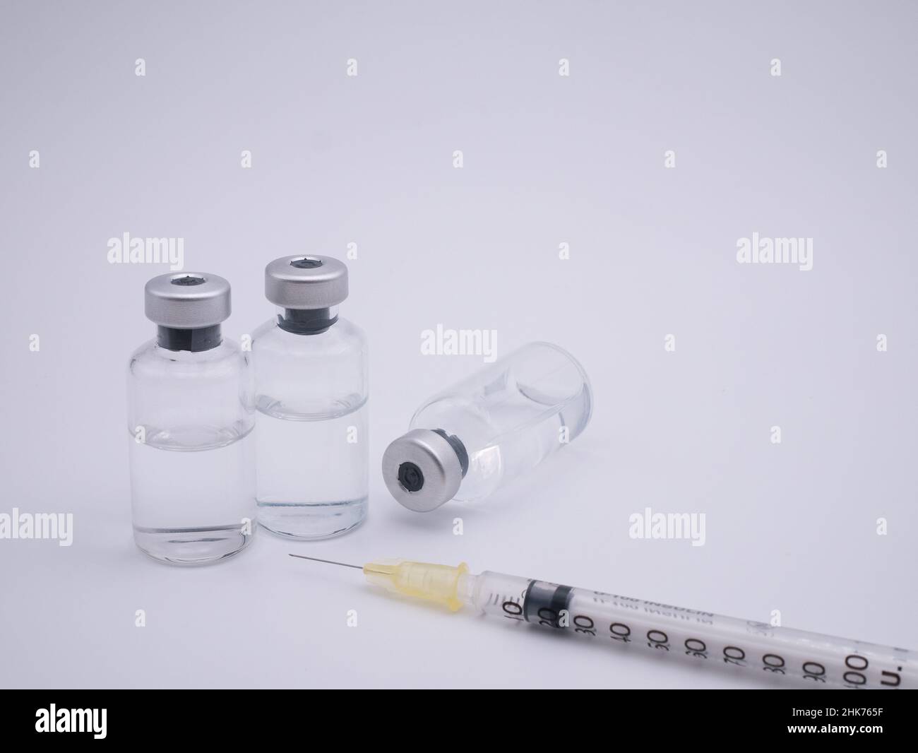 Trois flacons de vaccin avec seringue isolée sur fond blanc Banque D'Images