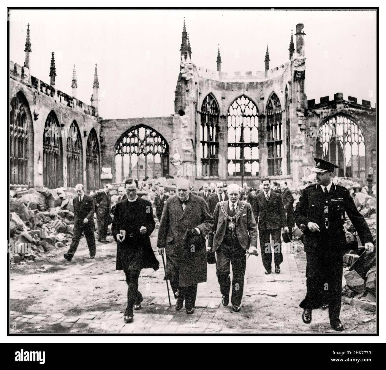Winston Churchill visite la cathédrale de Coventry le Premier ministre britannique Grim fact visite la cathédrale de Coventry severley endommagé par l'Allemagne nazie Luftwaffe attentat terroriste à la bombe Coventry UK 28th septembre 1941. Le Premier ministre Winston Churchill marche avec le maire de Coventry et un membre du clergé de l'Église d'Angleterre à travers la nef ruinée de la cathédrale de Coventry après qu'elle ait été bombardée par l'armée de l'air allemande en novembre 1940. Photographie officielle de guerre pour le gouvernement britannique. Banque D'Images