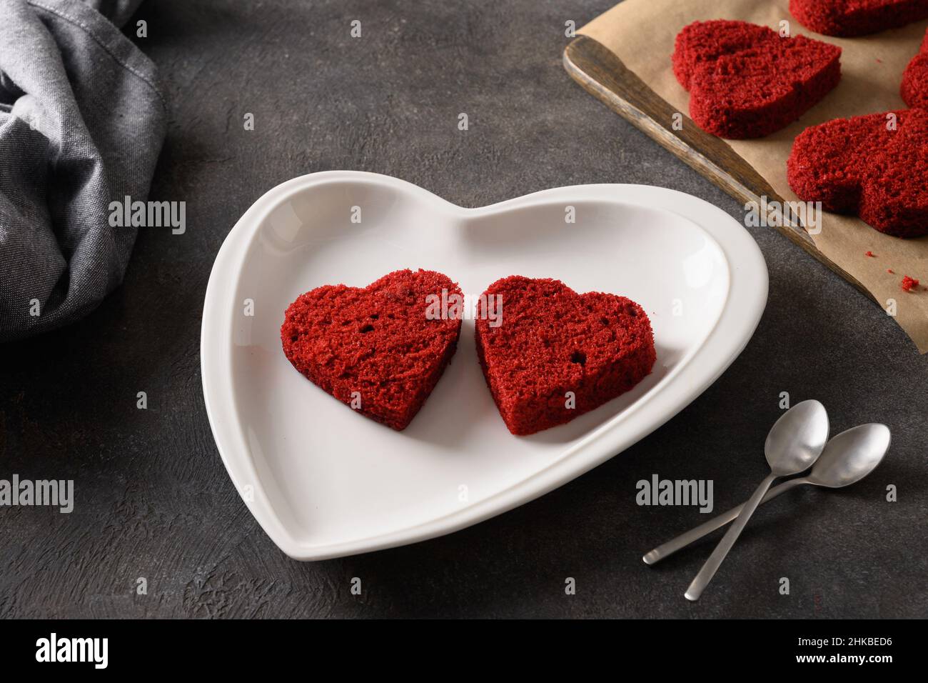 Faire un gâteau en velours rouge en forme de coeur pour deux pour la Saint-Valentin sur fond sombre.Délicieux dessert maison.Gros plan. Banque D'Images
