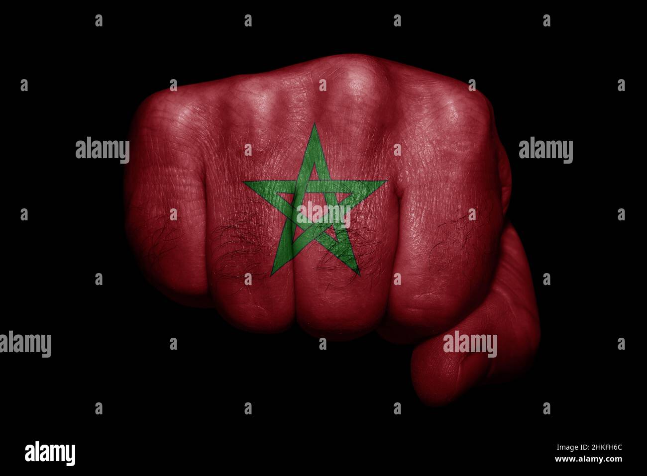 Drapeau du Maroc peint sur un poing fort sur fond noir Banque D'Images Drapeau du Maroc peint sur un poing fort sur fond noir Banque D'Images