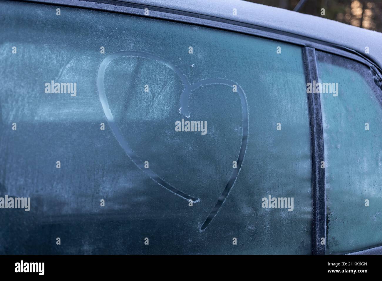 symbole de coeur sur la fenêtre grise de voiture gelée en hiver Banque D'Images