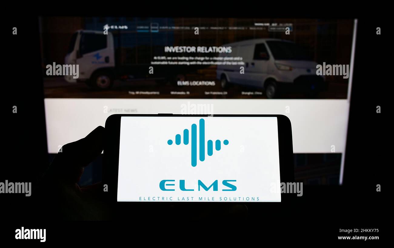 Personne tenant un téléphone portable avec le logo de la société américaine Electric Last Mile Solutions Inc. (ELMS) à l'écran devant la page Web. Mise au point sur l'affichage du téléphone. Banque D'Images