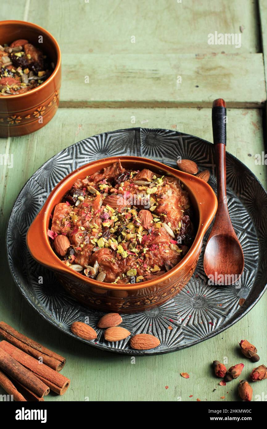 Cuisine arabe traditionnel égyptien dessert Om Ali ou Umm Ali.Pain de pâtisserie trempé, lait et charge de noix et raisins secs rôtis. Banque D'Images