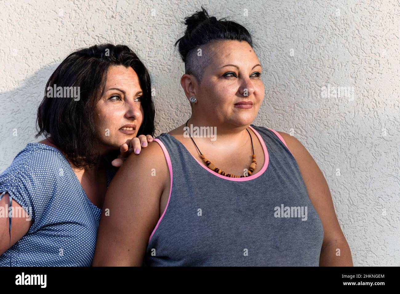 Portrait de deux sœurs jumelles brunette adultes regardant quelque chose.Différents styles Banque D'Images