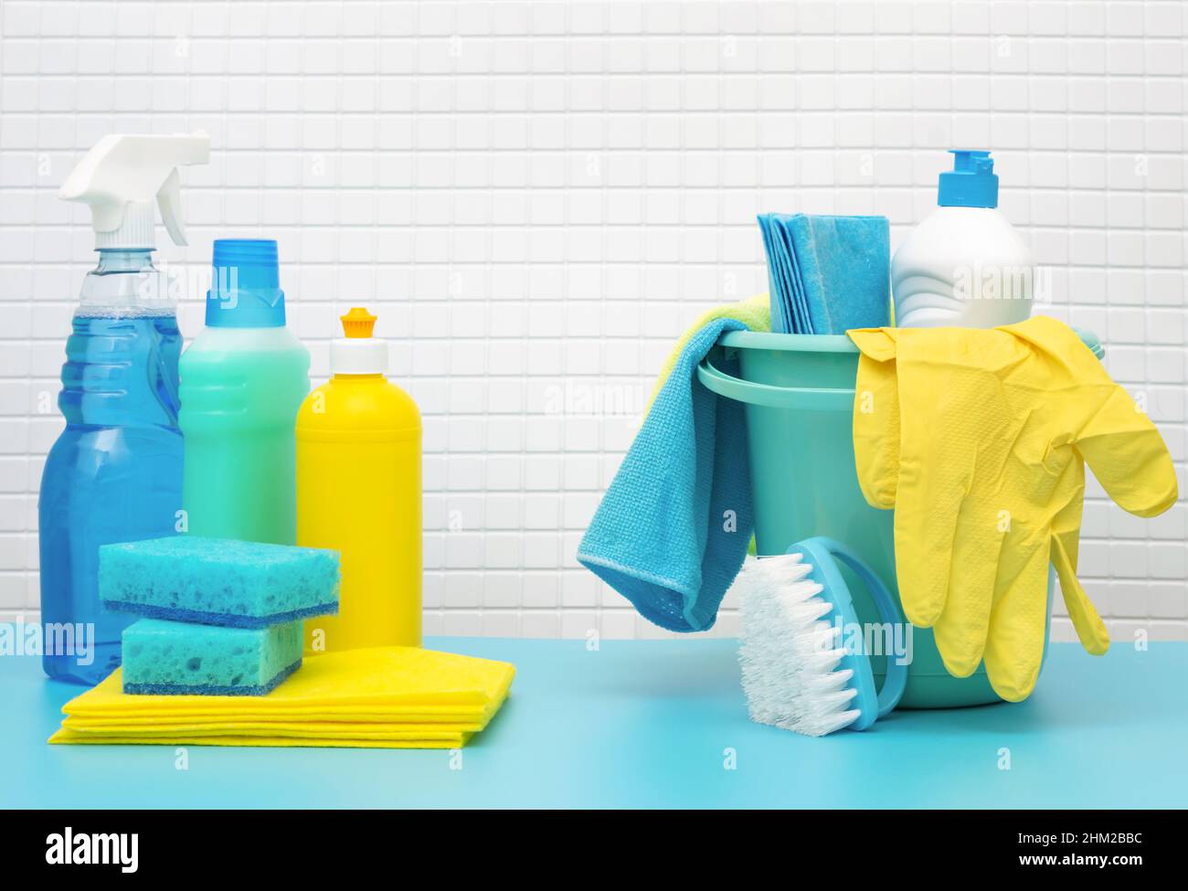 Nettoyants et détergents en seau, accessoires pour le nettoyage de diverses surfaces et pièces fond bleu Banque D'Images