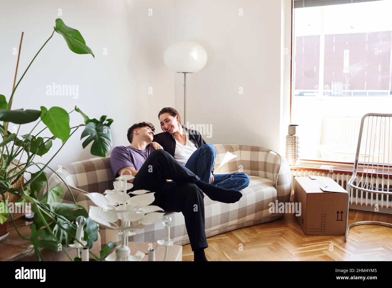 Young couple sitting on sofa Banque D'Images
