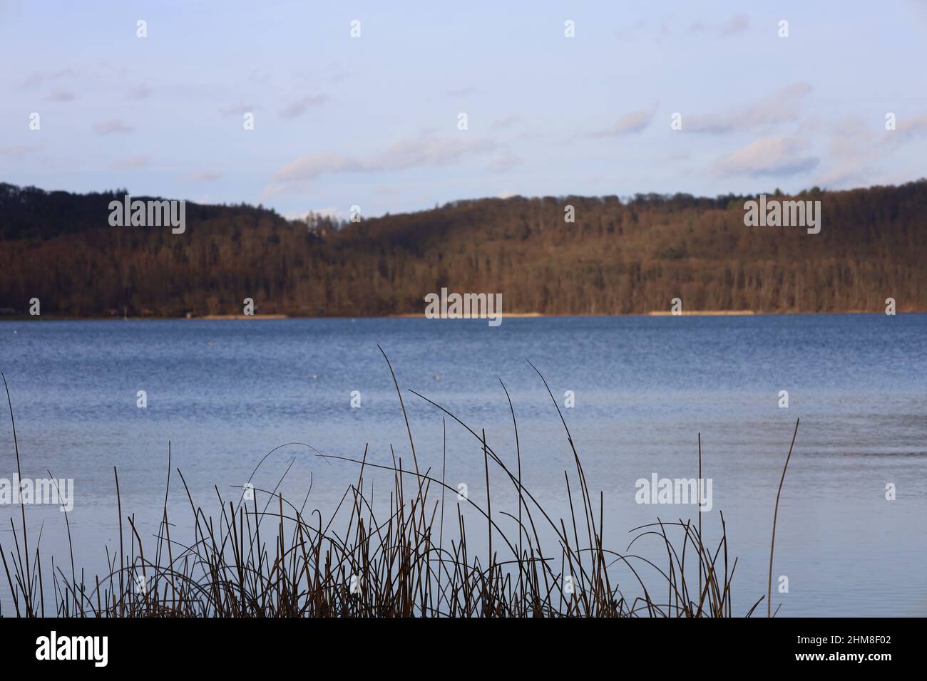 Maria Laach, Laacher See, Allemagne, février 2022, vue sur le lac juste avant le coucher du soleil dans la belle lumière du soleil et le temps avec ciel bleu Banque D'Images