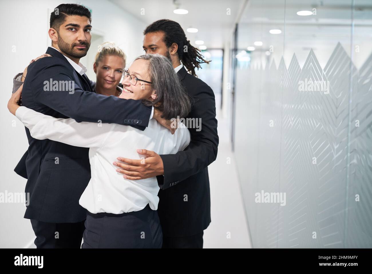 Une équipe d'affaires multiculturelle se tenant en cercle dans le bureau pour l'intégration et la création d'équipe Banque D'Images