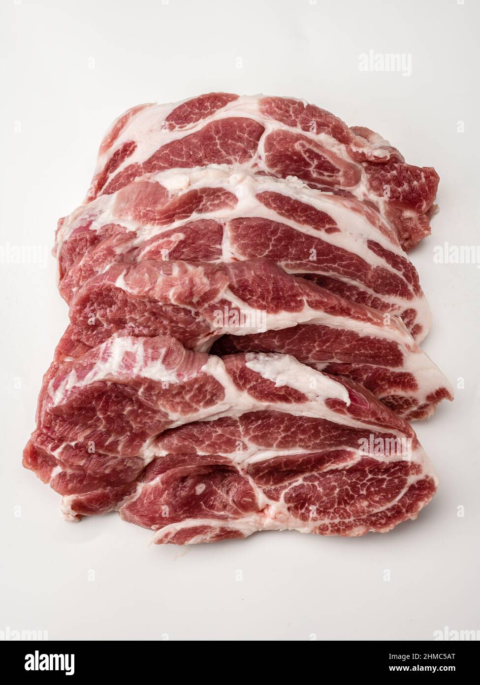 Gros plan sur les steaks de porc frais crus. Viande crue. Agneau de bœuf frais cru. Cuisson de la viande sur du blanc. Boucherie, marché, boutique. Viande de porc brute en tranches. Image pour Butch Banque D'Images