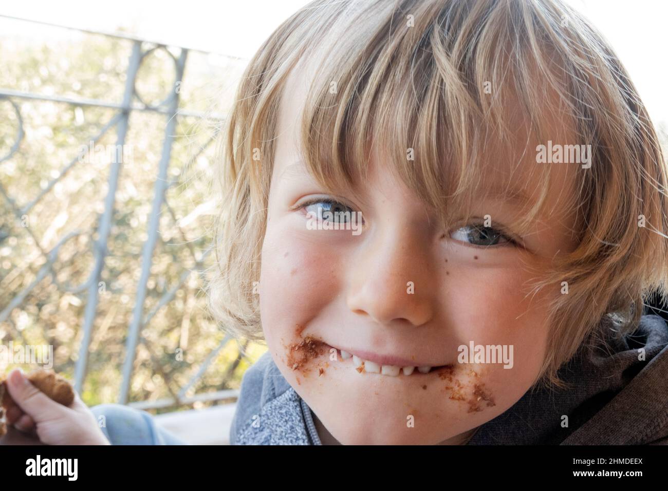 Gros plan sur le petit garçon mangeant des biscuits au chocolat Banque D'Images