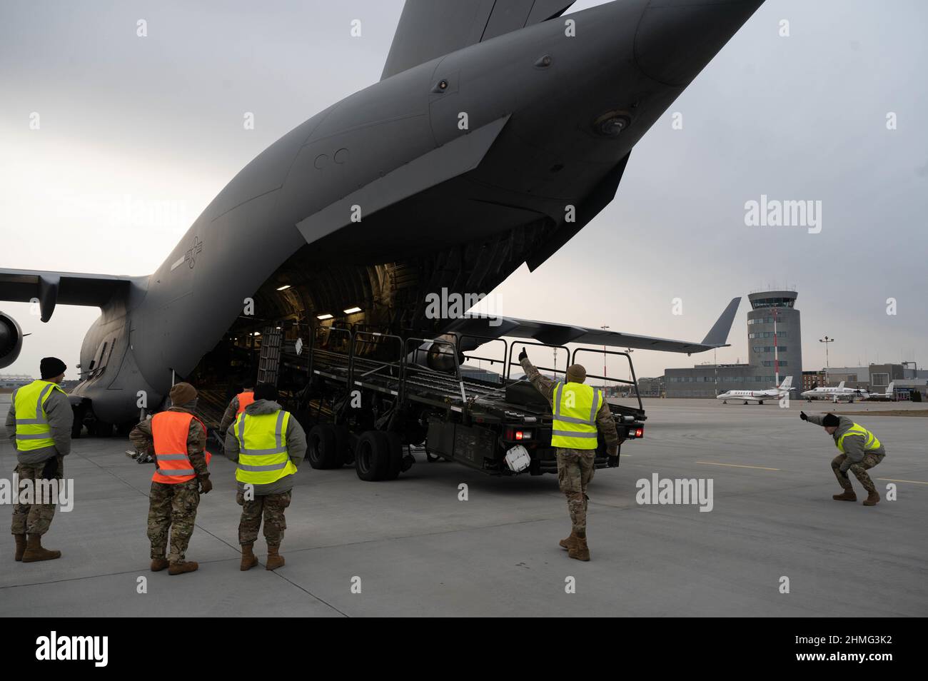 Les membres affectés à l'escadre des opérations aériennes au sol de 435th et à l'escadre des opérations de mobilité aérienne de 521st ont reçu un chargeur de fret de 60k aéronefs d'un C-17 Globemaster III affecté à l'escadre de transport aérien de 62nd de la base conjointe Lewis-McChord (Washington), à l'aéroport de Rzeszów-Jasionka (Pologne), le 8 février. 2022. Des membres de l'AMOW 521st et de l'AGOW 435th se sont déployés en Pologne pour préparer l'aéroport à l'arrivée de l'armée américaine. (É.-U. Photo de la Force aérienne par le premier Airman Taylor Slater) Banque D'Images