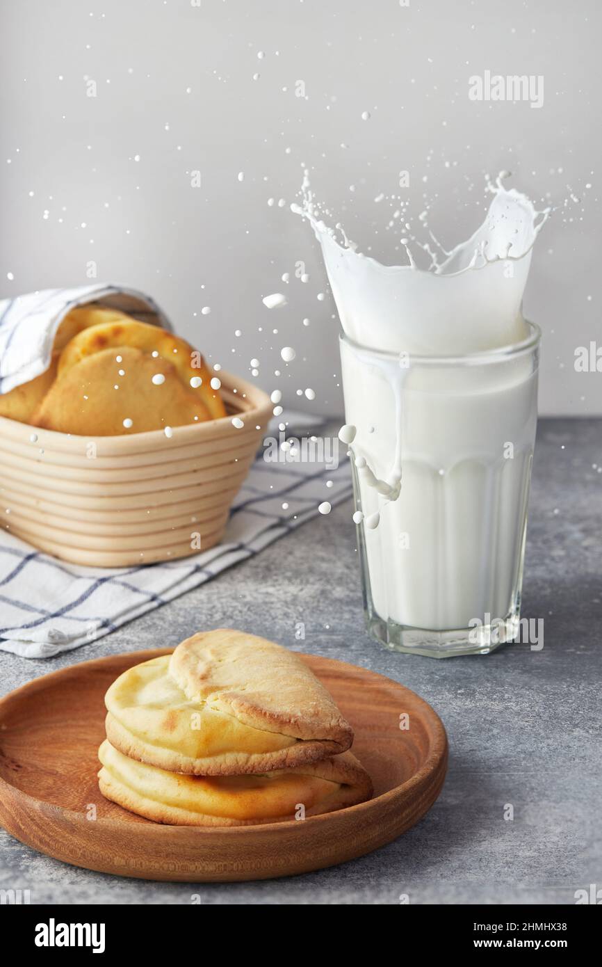 Biscuits de fromage cottage à sablés avec un verre de lait et une éclaboussure. Vue avant. Banque D'Images