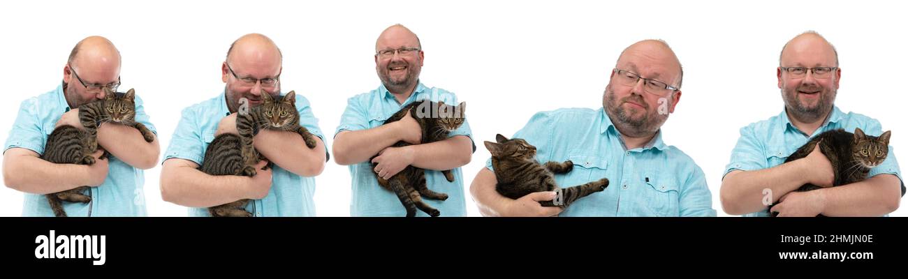 Beaucoup pose comme un homme chauve tient un chat-elle dans ses bras. Banque D'Images