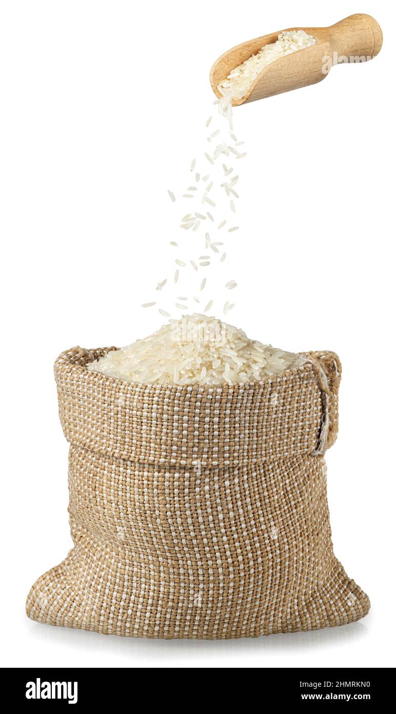 le riz tombe de la pelle en bois dans un sac de toile de jute Banque D'Images