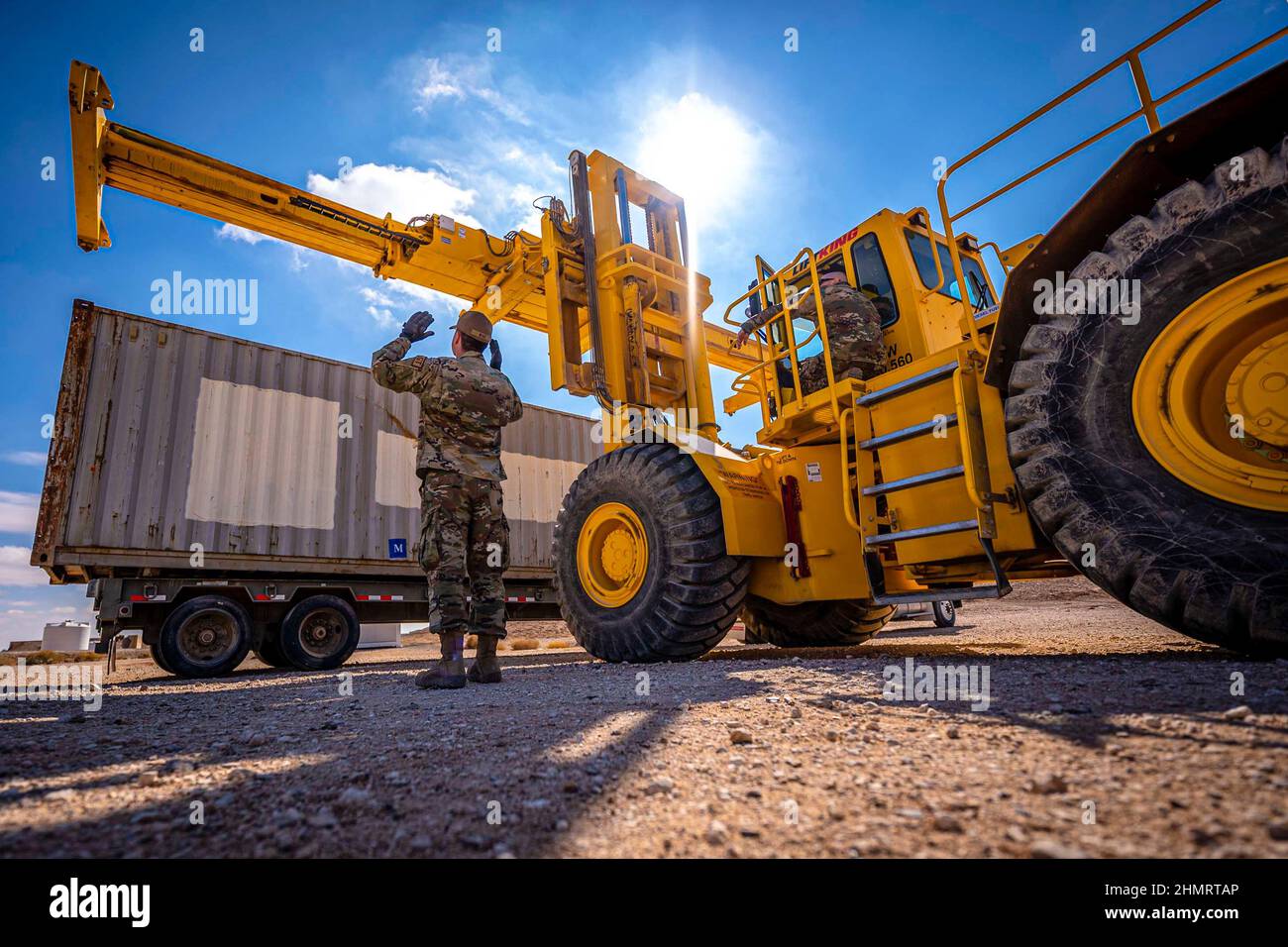 Emplacement non divulgué. 29th janvier 2022. Un airman de l'escadron de préparation à la logistique expéditionnaire 332D guide le préposé aux conteneurs du terrain Ruff lors d'une démonstration pour le Sgt principal. Sean M. Milligan, 332D Chef de commandement de l'escadre expéditionnaire de l'air, lors de la tournée d'immersion du chef de commandement en Asie du Sud-Ouest, le 29 janvier 2022. Les pelles pour manutention de conteneurs terrain Ruff sont utilisées par transport terrestre pour décharger les conteneurs d'expédition. Les visites d'immersion du chef Milligan lui permettent de mieux comprendre les compétences uniques que chaque Airman apporte à l'équipe de red Tail 332D d'AEW. (Credit image: © Air Force/ZUMA Press Banque D'Images