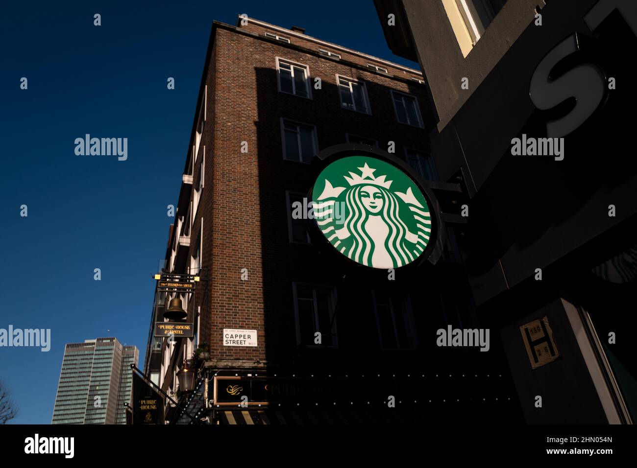 Logo Starbucks prenant la lumière du soleil sur Tottenham court Road lors d'une journée hivernale froide à Londres, Royaume-Uni Banque D'Images