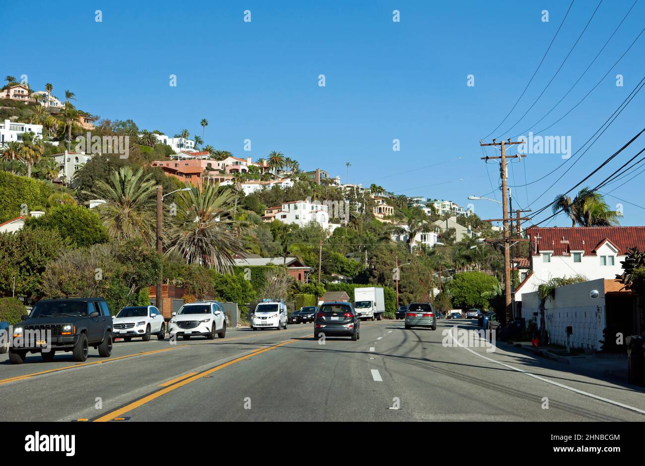 Voitures sur PCH à Malibu avec vue sur l'océan sur les maisons à flanc de colline Banque D'Images