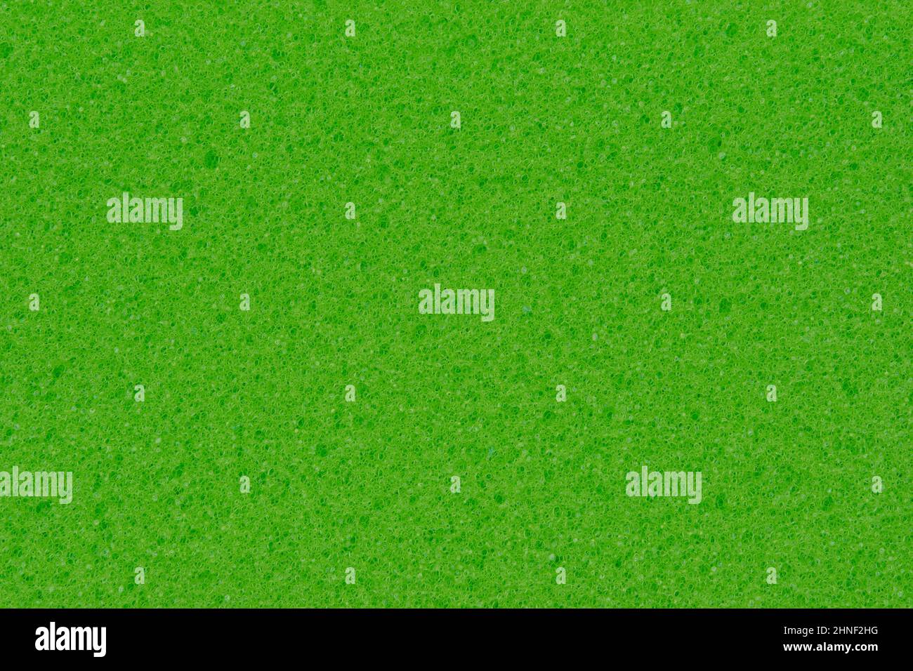 Texture d'une éponge en mousse pour laver la vaisselle. Fond d'éponge verte pour le nettoyage. Banque D'Images