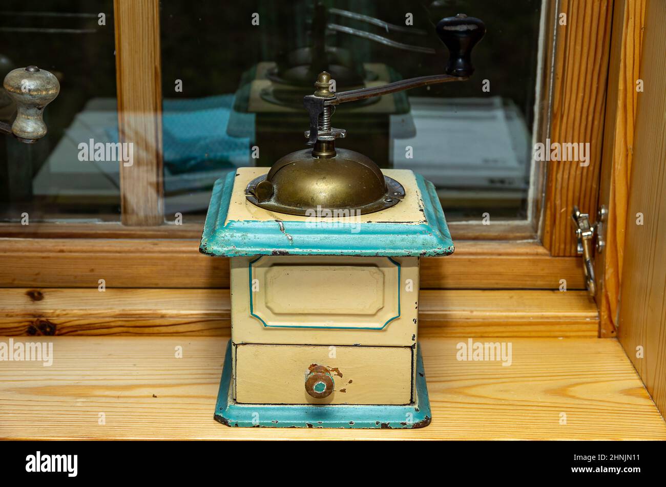 Ancien moulin à main nostalgique pour le café moulu ou similaire sur le seuil de la fenêtre. Banque D'Images