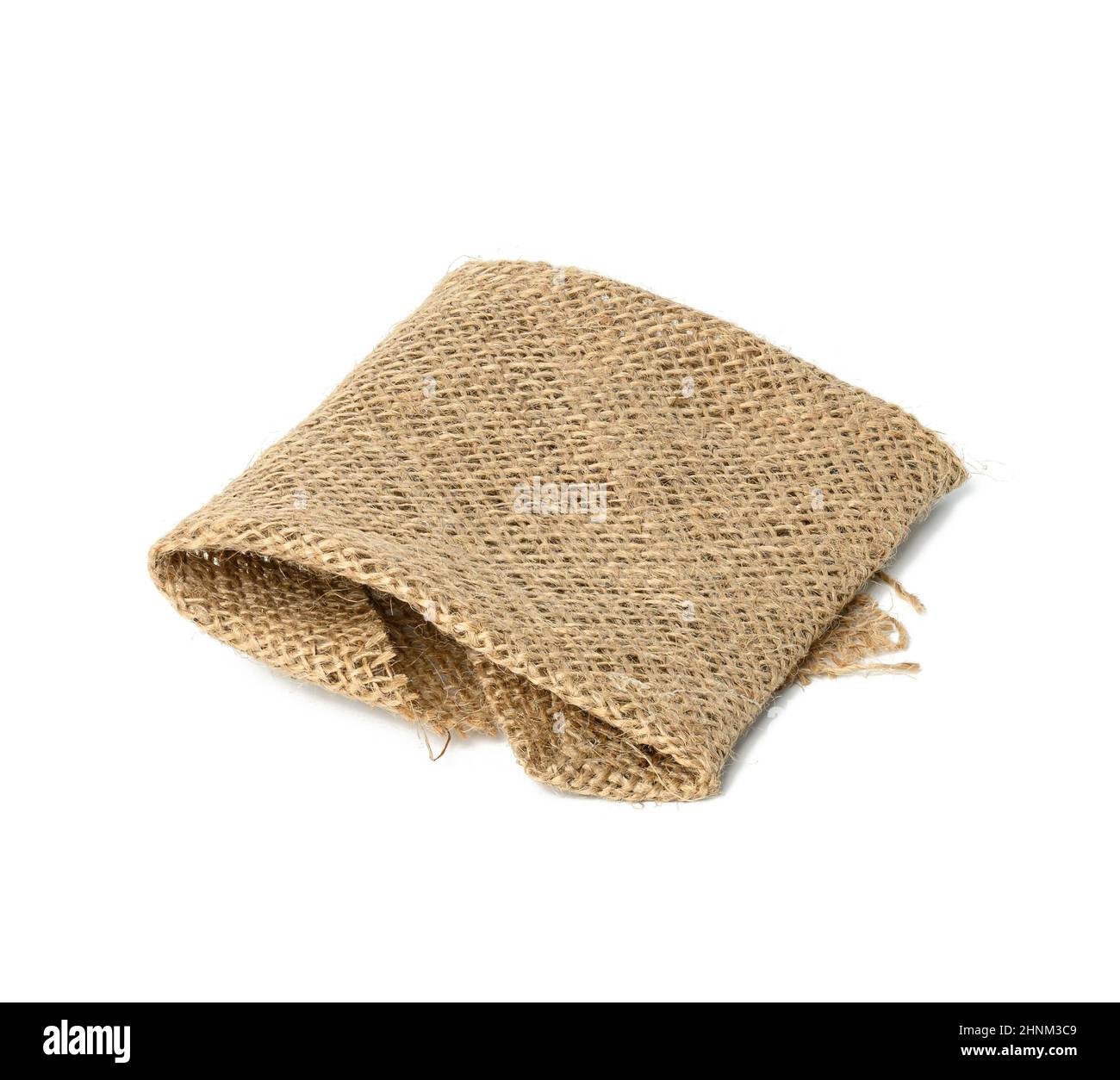 tissu brun en toile de jute plié et isolé sur fond blanc Banque D'Images
