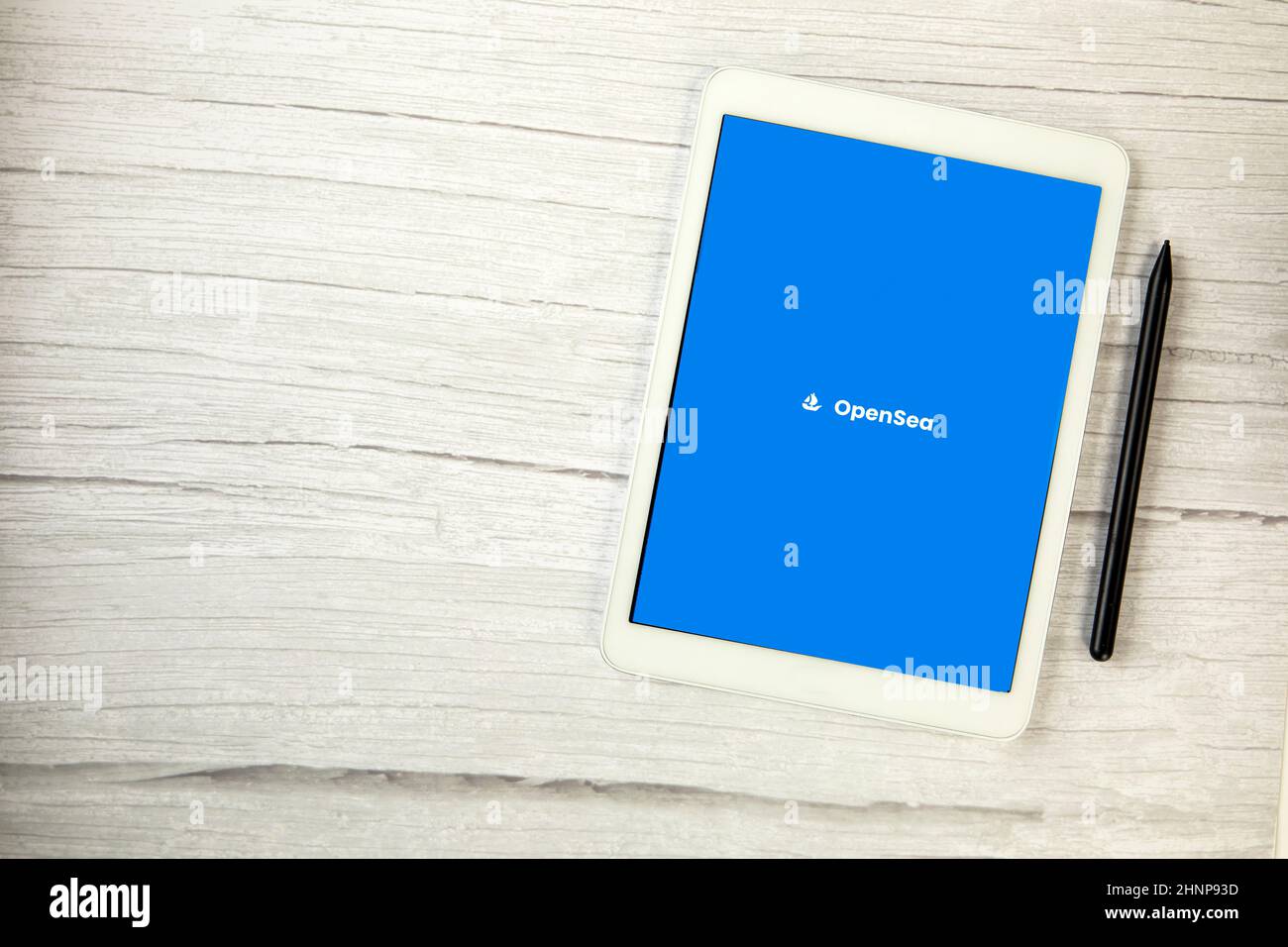 Pays-Bas, décembre 2021 application Opensea sur tablette numérique blanche sur table en bois avec espace de copie, place de marché pour les jetons non fongibles NFT art numérique Banque D'Images