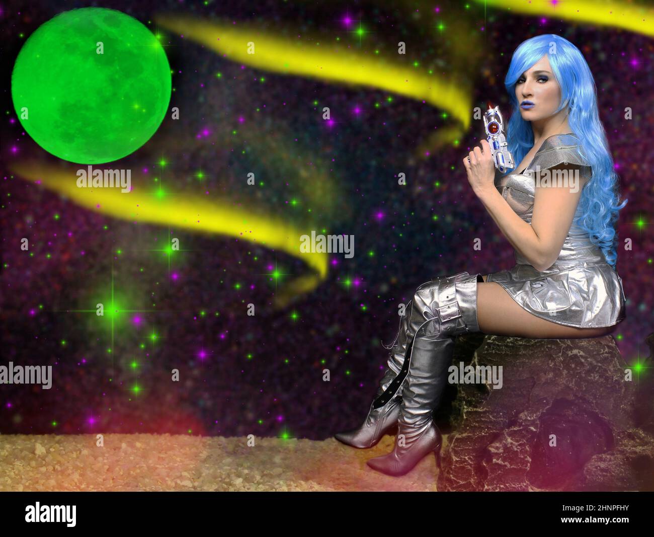 Femme extraterrestre aux cheveux bleus et à la lune verte tenant un Ray Gun Banque D'Images