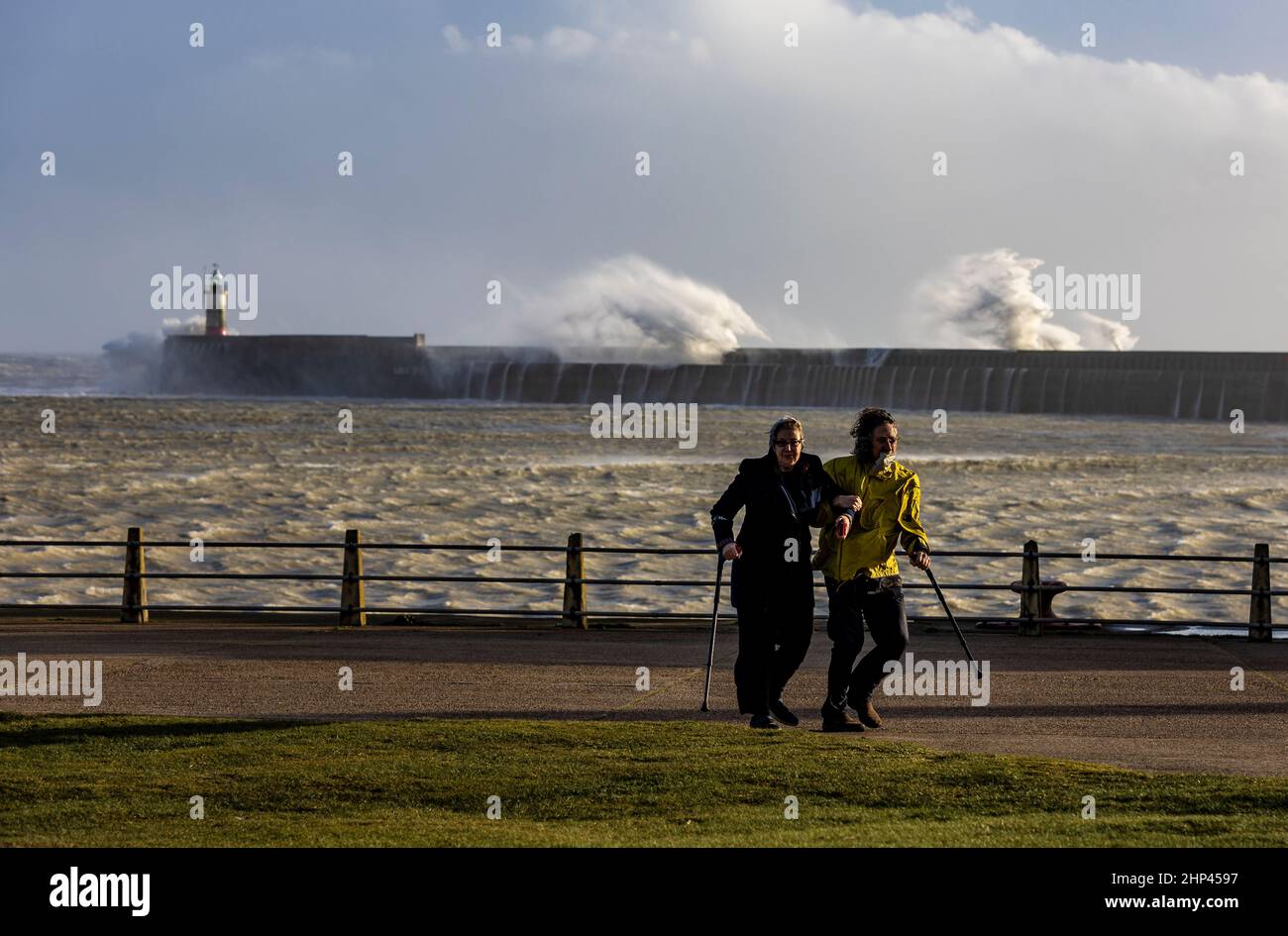 Newhaven Lighthouse, Royaume-Uni, 18th février 2022. Un membre du public se promène après avoir regardé les vagues sur le mur de la mer du phare de Newhaven dans l'après-midi alors que Storm Eunice balaye la côte sud de l'Angleterre dans l'ouest du Sussex. Crédit : Steven Paston/Alay Live News Banque D'Images